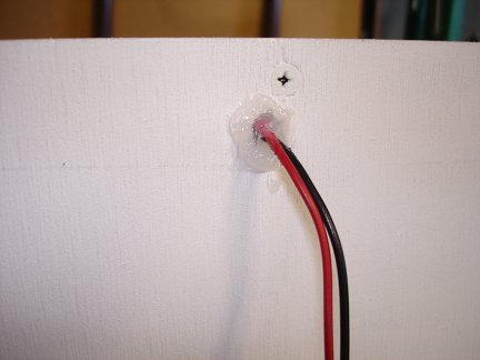 The wires exit the panel at the top rear