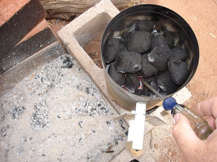Heating up a screwdriver over a charcoal fire